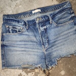 Good American faded blue denim shorts with frayed hem